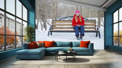 young woman posing on a background of a winter park Wall mural