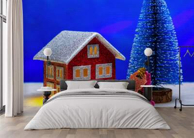 On a blue background there is a house with bright yellow light in the windows and keys under a blue Christmas tree Wall mural