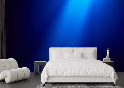 On a dark blue finely textured background, a blue beam of light shines from above Wall mural