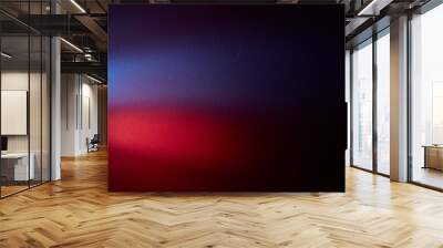 On a dark gradient background the volume blurry glow of red and violet color Wall mural