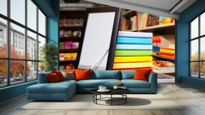 Stack of colorful books with electronic book reader Wall mural