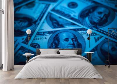 Background from dollars. Notes of one hundred American dollars are scattered across the background. Wall mural