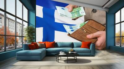 Investing money to Finland. Rich man with a lot of money. Wall mural