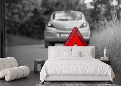 Red warning triangle and broken car on the road Wall mural