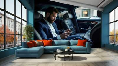 Businessman Using Smartphone in Chauffeured Car Wall mural