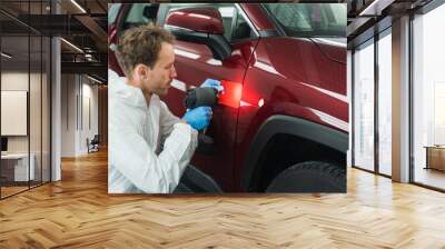 Professional auto painter matches car paint color with lamp and samples Wall mural