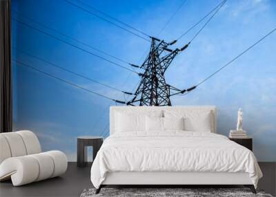 High voltage electricity pylon and transmission power line on the blue sky and white clouds on the background. Parts of electrical equipment and high voltage power line insulators. Wall mural