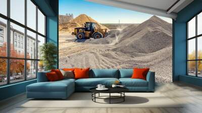 A large powerful loader overloads a pile of rubble in a concrete plant. Wall mural