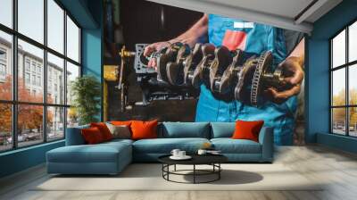 Auto mechanic repairs the crankshaft in the garage. Repair service. Wall mural