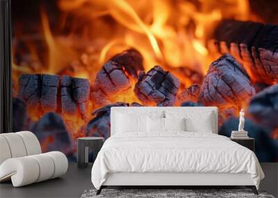 Flames and glowing embers creating warmth in a campfire at dusk Wall mural