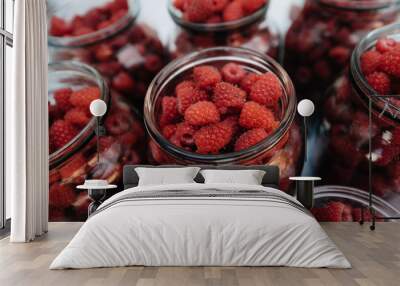 Fresh, ripe raspberries in small jars close-up Wall mural