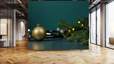 Gold ornament and pinecone on green table Wall mural