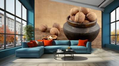 group of walnuts on a wooden background. Wall mural