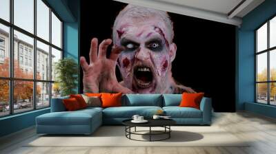 Sinister man with horrible scary Halloween zombie makeup in convulsions making faces, looking ominous, trying to scare. Dead guy with wounded bloody scars face isolated against black wall background Wall mural