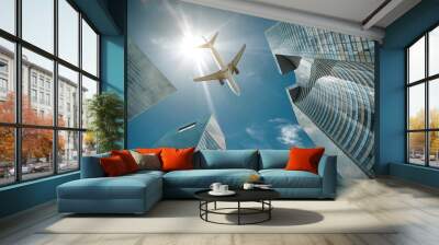 Airlane flying over modern glass and steel office buildings near Wall mural