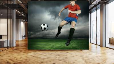 Football player with ball in action outdoors Wall mural