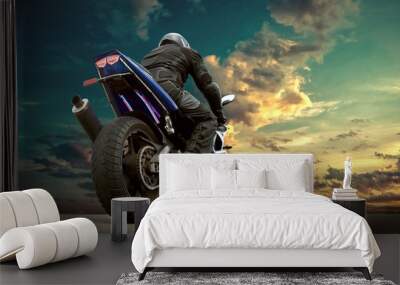 Man seat on the motorcycle under sky with clouds Wall mural