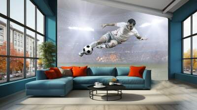 Soccer player with ball in action on field of stadium Wall mural