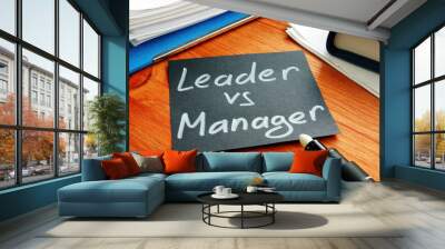 Leader vs manager is shown on the conceptual business photo Wall mural