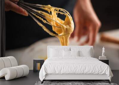 female cook mixing muffin dough with a metal whisk. Home baking concept. Wall mural