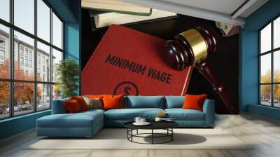 Minimum wage increase and minimum wage law are shown using the text on the book and photo of gavel Wall mural