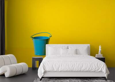 paint service concept. blue bucket over yellow background. design and decor conceptual Wall mural