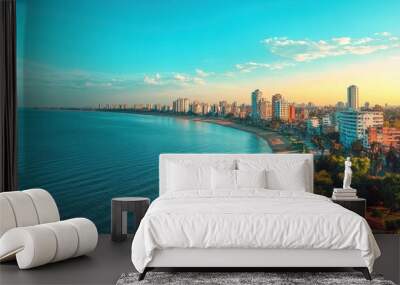 Serene coastal view at sunset near city skyline Wall mural