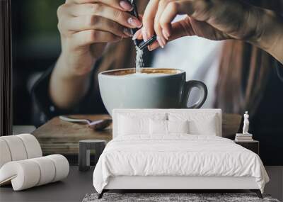 The girl's hand pours sugar into her coffee. Close up Wall mural