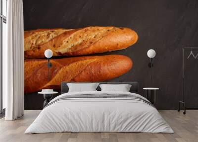 Two crispy french baguettes lie on an old wooden table with free space for text Wall mural