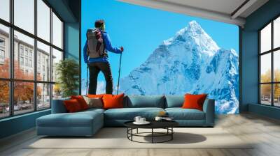 Hiker with backpacks reaches the summit of mountain peak. Success, freedom and happiness, achievement in mountains. Active sport concept. Wall mural