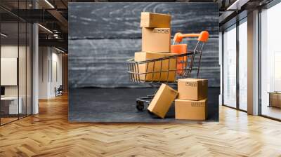 A supermarket cart loaded with cardboard boxes. Sales of goods. concept of trade and commerce, online shopping. high. delivery order. purchasing power of the population and the state of the economy Wall mural