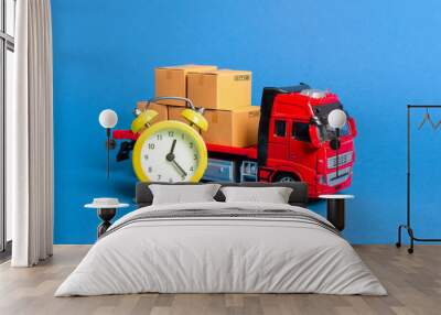 A truck with cargo cardboard boxes and a yellow alarm clock. Express delivery in short time concept. Temporary storage, limited offer and discount. Optimization of delivery logistics Transport company Wall mural