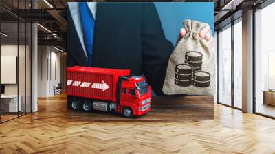 Businessman with money bag and truck. High income of the transport business and the transport of goods. Rising prices, global containers shortage crisis. Logistics. Good salaries for drivers. Wall mural