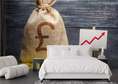 Pound sterling GBP symbol money bag and red trend arrow up chart. Deposit and savings. Increasing profits and revenues, capital growth, profitable business efficiency. Economic prosperity welfare rise Wall mural