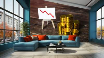 Stacks of coins and a down arrow chart. Fall in savings. Expenses and losses, the risk of losing savings. Unsuccessful investment. Falling profits, withdrawal of capital investments. Economic decline Wall mural