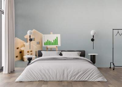 Wooden houses with a stand of graphics and information. Growing demand for housing and real estate. growth of the city and its population. Investments. banner, place for text. Selective focus Wall mural