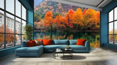 A beautiful autumn scene with a lake and trees. The water is calm and the trees are full of bright orange leaves Wall mural