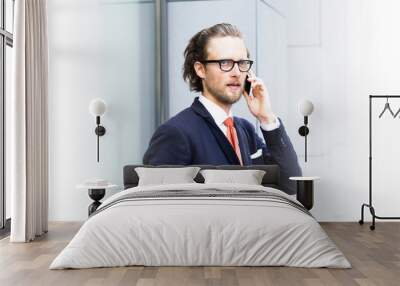 A businessman with a beard and glasses talking on the phone. Space for text. Wall mural