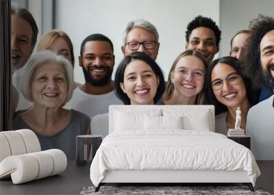 A group of people are smiling for the camera. The group is diverse, with people of different ages and races. Scene is happy and friendly, as everyone is posing together and enjoying the moment Wall mural