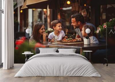 A happy family enjoys a delightful outdoor dinner together, savoring pizza and creating cherished memories. Wall mural