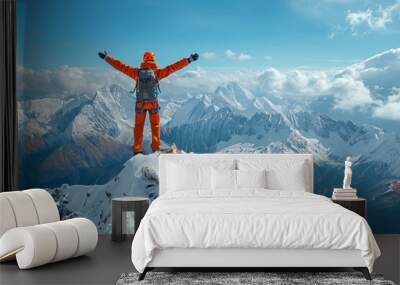 A lone climber stands triumphantly atop a snow-covered mountain peak, basking in the sunny wilderness Wall mural