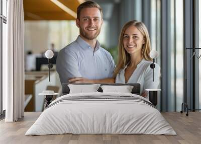 A man and woman are smiling for the camera in a room with a window. Scene is happy and friendly Wall mural