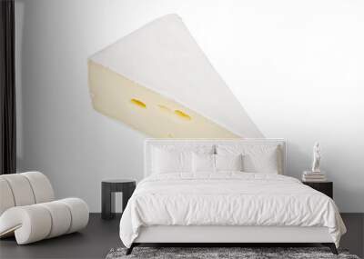 A piece of yellow brie cheese on a white background. Close-up. Wall mural