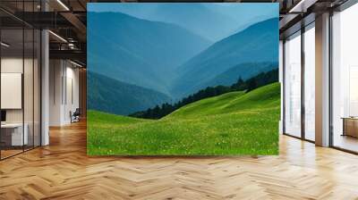 A serene highland landscape with lush green pastures, rolling hills, and majestic mountains. Wall mural