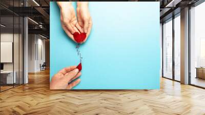 Blood donor. Hands with red heart and drop. Medical donation and blood transfusion. Wall mural