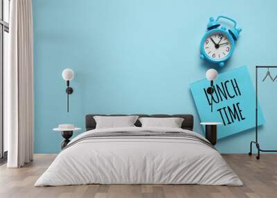 Blue alarm clock and paper reminder lunch time. Wall mural