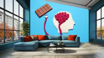 Figure of man and bar of sweet chocolate. Nutrition brain energy for mind. Wall mural