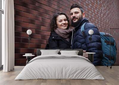 Portrait of joyful caucasian couple in love or friends with backpacks ready for a trip or hike. Wall mural