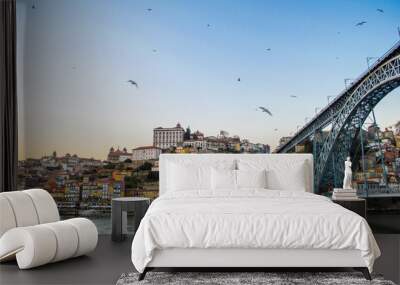 Old Porto cityscape skyline with Dom Luis I Bridge and flying seagulls above the Douro River in sunset time in Porto, Portugal Wall mural