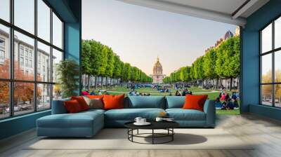 The National Residence of the Invalids and people sitting on a grass in Paris, France Wall mural